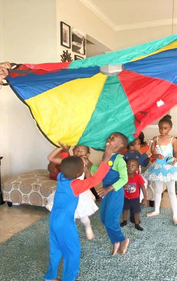Kids playing parachute game at the party 