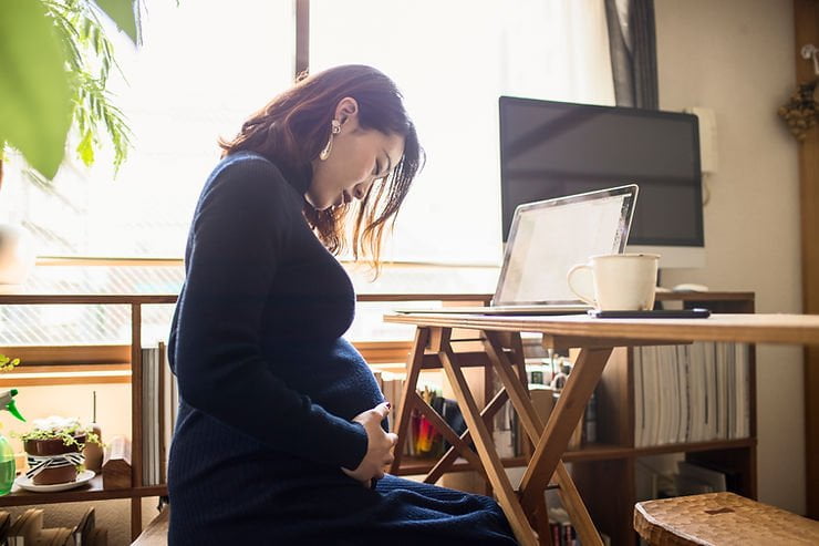A MOM AT WORK WHILE BEING PREGNANT